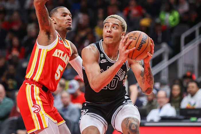 San Antonio Spurs forward Jeremy Sochan being guarded by Atlanta Hawks guard Dejounte Murray.